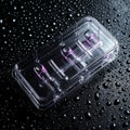 Lidless transparent plastic container on a wet surface Royalty Free Stock Photo