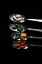 Lie on the surface of a spoon with pills. Drug addiction concept