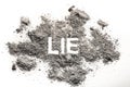 Lie word written in ash, dust, sand
