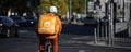 a lieferando food cyclist in berlin as panorama