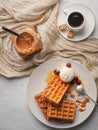 Liege Belgian waffles with caramel, berries and ice cream. Selective focus, top view. Sweet dessert Royalty Free Stock Photo