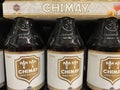 Closeup of beer crates with bottles with logo lettering of belgian chimay brewery in supermarket