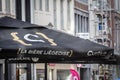 LIEGE, BELGIUM - NOVEMBER 9, 2022: Selective blur on a Curtius sign on a retailer umbrella in Liege. Biere curtius is a light beer