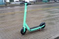 LiepaÂja, Latvia - 04.01.2023: Parked Bolt green electric scooter on sidewalk