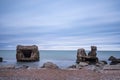 Liepaja beach bunker. Brick house, soft water, waves and rocks. Abandoned military ruins facilities in a stormy sea.