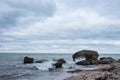 Liepaja beach bunker. Brick house, soft water, waves and rocks. Abandoned military ruins facilities in a stormy sea.