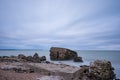 Liepaja beach bunker. Brick house, soft water, waves and rocks. Abandoned military ruins facilities in a stormy sea.