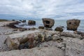 Liepaja beach bunker. Brick house, soft water, waves and rocks. Abandoned military ruins facilities in a stormy sea.