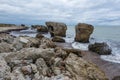 Liepaja beach bunker. Brick house, soft water, waves and rocks. Abandoned military ruins facilities in a stormy sea.