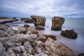 Liepaja beach bunker. Brick house, soft water, waves and rocks. Abandoned military ruins facilities in a stormy sea.