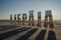 Liepaja city title at Baltic beach. Big mirroring letters in sunny evening