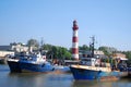 Liepaja, Latvia - May 31, 2011: A port with ships, lighthouse and buildings on a sunny day