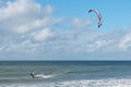 Liepaja, Latvia - September 29, 2019: Kiteboarder kitesurfer athlete performing kitesurfing in sea. Blue, cloudy sky