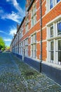 View on brabant style house block, red brick and soapstone facings of soft white stone, cobblestone street