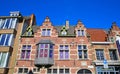 View on isolated red brick facade of medieval belgian house, gabled roof, bay window, clear blue sky Royalty Free Stock Photo