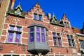 View on isolated red brick facade of medieval belgian house, gabled roof, bay window, clear blue sky Royalty Free Stock Photo