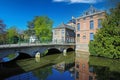 View over water town moat on medieval romantic old cityscape, ancient stone bridge, clear blue sky