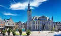 View over market square with medieval buildings and town hall, blue sky