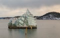 Oslo, Norway - Marc 16, 2018: She Lies, sculpture designed by Monica Bonvicini, floating in the ocean water next to the Royalty Free Stock Photo