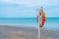 Life ring beach sea buoy orange closeup saving rescue round, concept red guard from emergency from ocean assistance Royalty Free Stock Photo