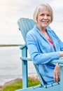 Life begins at retirement. Portrait of a happy senior woman relaxing on a chair outside. Royalty Free Stock Photo