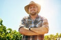 Life is better on the farm. a middle-aged farmer posing on a vineyard.