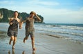 Life is better when youre barefoot. a happy young couple holding hands while running along the beach. Royalty Free Stock Photo