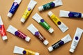 Life is a blank canvas until you add some colour. Studio shot of a various coloured paints against a brown background.