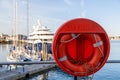 a life boy at a marina with out of focus yachts in the background