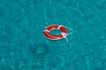 Life buoy in blue swimming pool. Lifebuoy pool ring float on blue water. Royalty Free Stock Photo