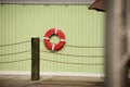 Life buoy hanging on wooden wall Royalty Free Stock Photo