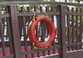 Life buoy hanging on wooden wall for emergency response when people sinking to water almost place near pool and beach photo Royalty Free Stock Photo
