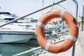 Life buoy hung on a railing in the port. Royalty Free Stock Photo