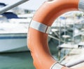 Life buoy hung on a railing in the port. Royalty Free Stock Photo