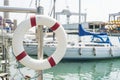 Life buoy hung on a railing in the port. Royalty Free Stock Photo