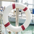 Life buoy hung on a railing in the port. Royalty Free Stock Photo