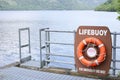 Life buoy orange red ring water safety prevention drowning scenic view inversnaid Loch Lomond Scotland uk Royalty Free Stock Photo