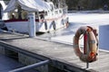 Life buoy orange ring water safety at boat mooring marina Royalty Free Stock Photo
