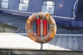 Life buoy orange ring water safety at boat mooring marina Royalty Free Stock Photo
