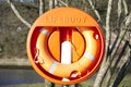 Life buoy orange ring water safety at boat mooring marina