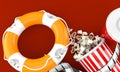 Life buoy with popcorn and film reel Royalty Free Stock Photo