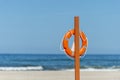 Life buoy preserver on sandy beach somewhere Royalty Free Stock Photo