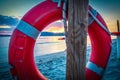 Life buoy by the sea in Alghero shore at sunset Royalty Free Stock Photo