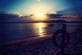 Life buoy by the sea at a scenic sunset Royalty Free Stock Photo