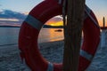 Life buoy by the sea at sunset Royalty Free Stock Photo