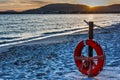 Life buoy by the sea at sunset Royalty Free Stock Photo