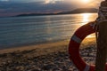 Life buoy by the shore at sunset Royalty Free Stock Photo