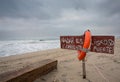 Life buoy and sign dangerous to swim Royalty Free Stock Photo