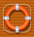 Life buoy on wood background Royalty Free Stock Photo