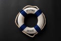 life buoy written with welcome aboard on dark background